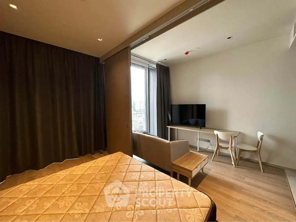 Modern studio apartment with cozy living area and city view
