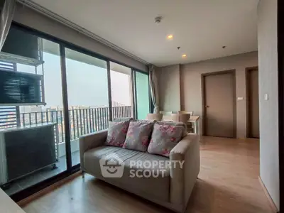Spacious living room with balcony and city view in modern apartment