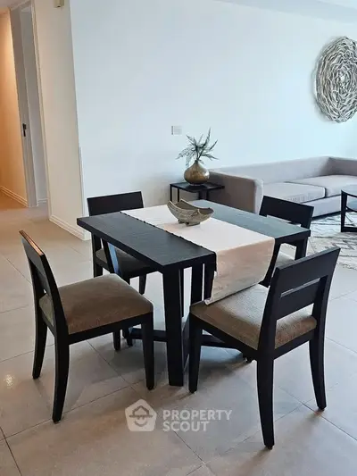 Modern dining area with elegant table and chairs in a stylish living room setting.