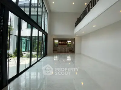 Spacious modern living room with high ceilings and large windows