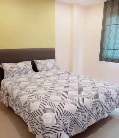 Cozy bedroom with stylish bedding and modern decor, perfect for relaxation and comfort.