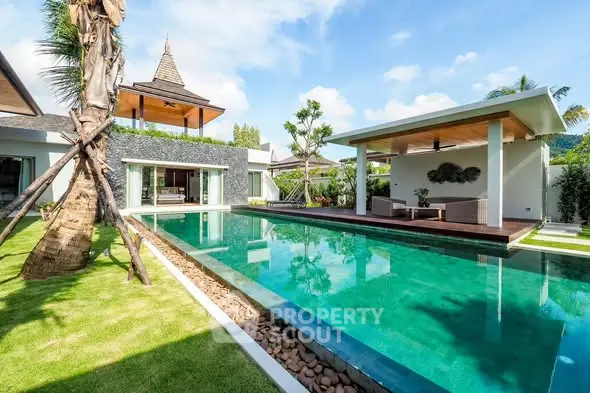 Luxurious villa with private pool and lush garden in tropical paradise setting.