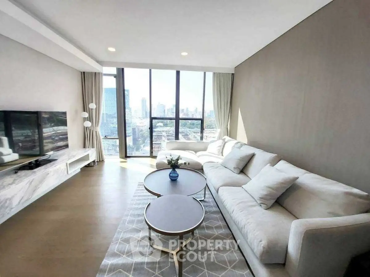 Luxurious living room with panoramic city view, modern furniture, and elegant decor.
