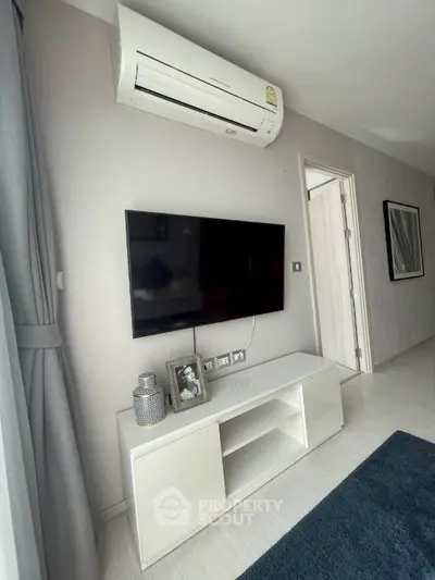Modern living room with wall-mounted TV and air conditioning unit