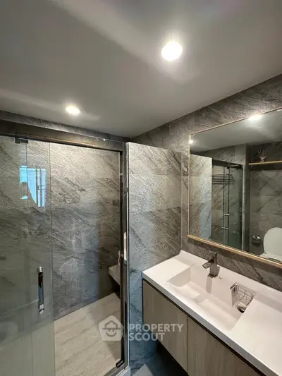 Luxurious modern bathroom with sleek design and glass shower enclosure