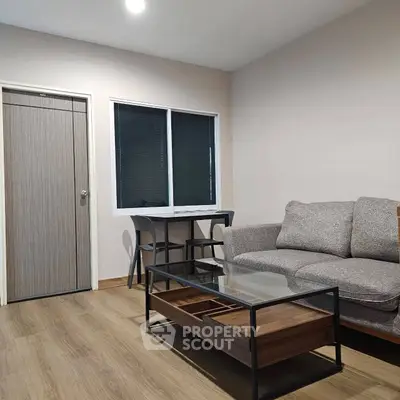 Modern living room with cozy sofa and stylish glass coffee table