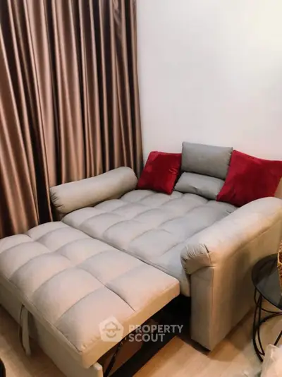 Cozy living room with plush sofa bed and elegant curtains