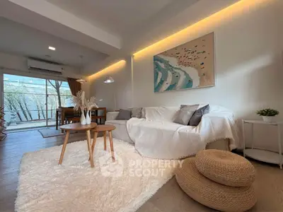 Stylish living room with cozy decor and natural light, perfect for relaxation.