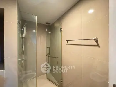 Modern bathroom with glass shower enclosure and sleek tile design