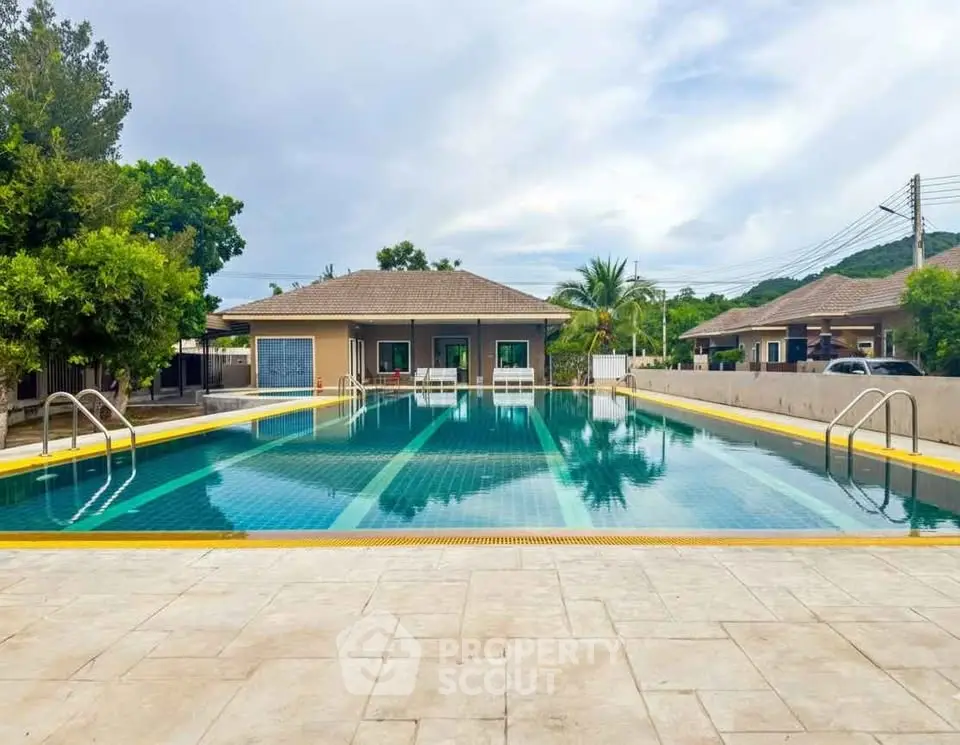 Stunning residential pool area with modern amenities and lush surroundings.