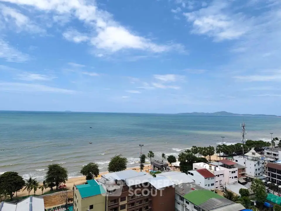 Stunning beachfront view from a high-rise building overlooking the ocean and coastline.