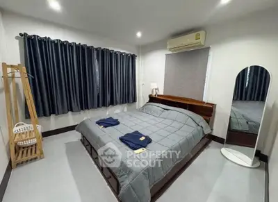 Spacious bedroom with modern decor and ample natural light