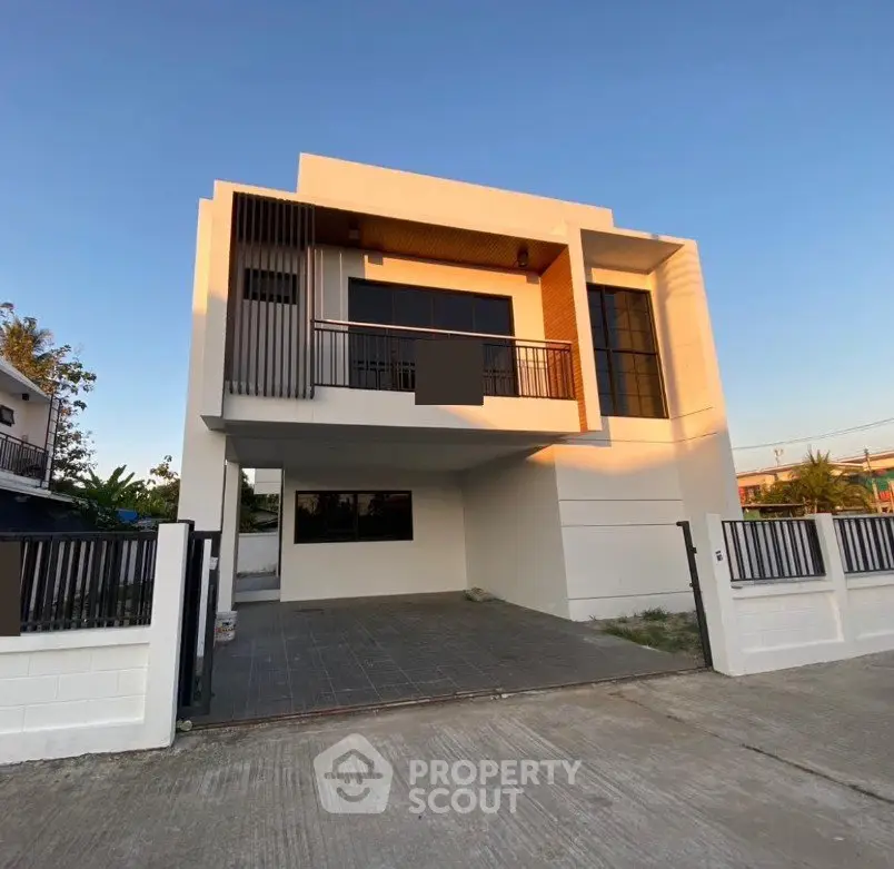 Modern two-story house with sleek design and spacious driveway in a serene neighborhood.