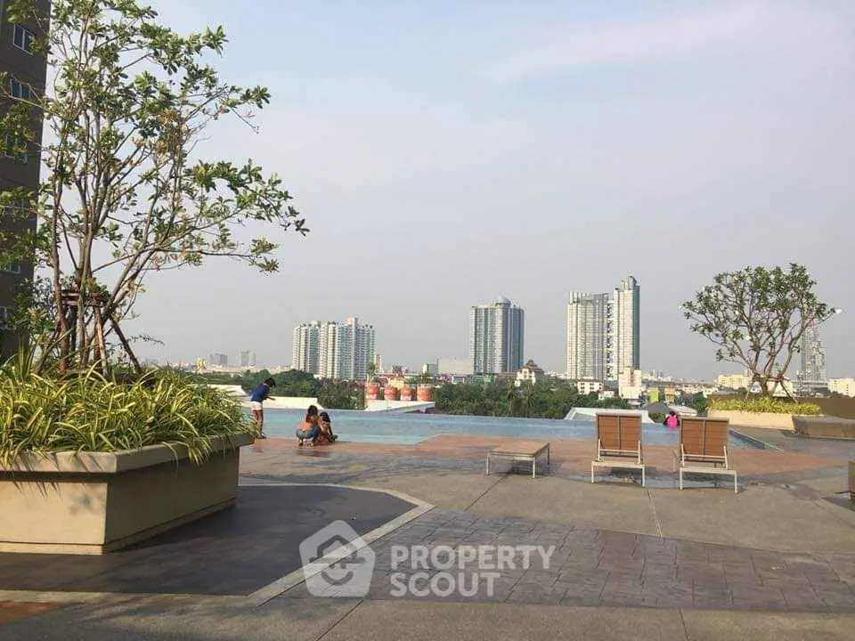 Luxurious rooftop pool with stunning city skyline views and relaxing lounge chairs.