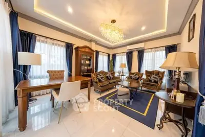 Luxurious living room with elegant furniture and chandelier, perfect for sophisticated gatherings.
