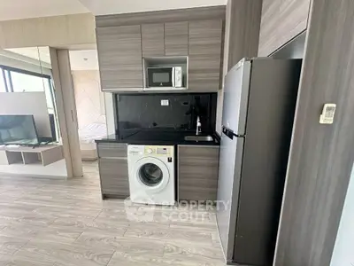 Modern kitchen with washing machine and fridge in stylish apartment