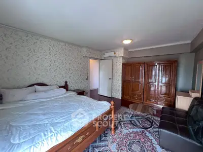 Spacious bedroom with elegant wooden furniture and cozy decor