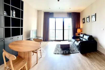 Spacious living room with modern furniture and large window view