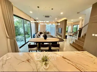 Luxurious open-plan living room with modern decor and garden view