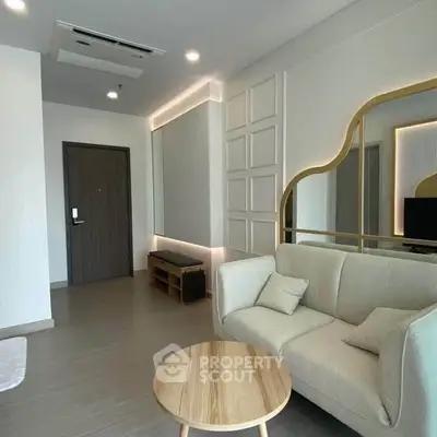 Modern living room with stylish sofa and unique wall mirror design