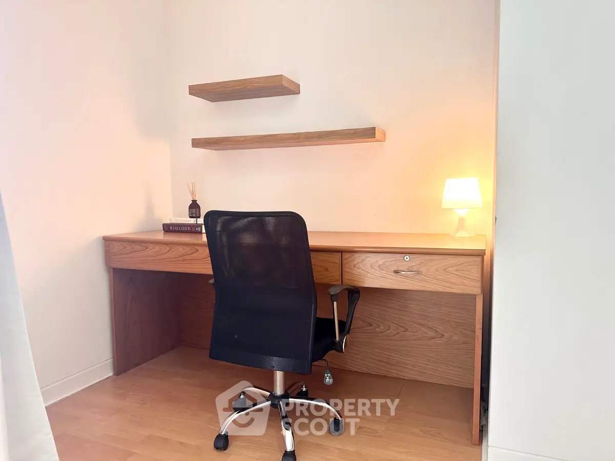 Modern study room with wooden desk, chair, and ambient lighting