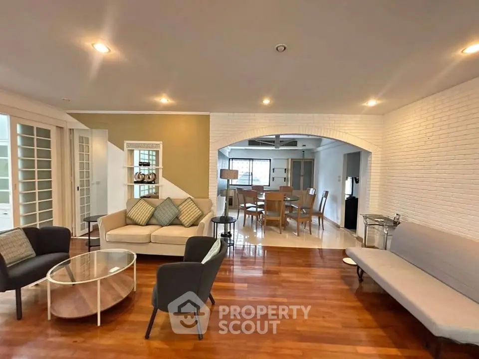 Spacious living room with elegant wooden flooring and modern furniture