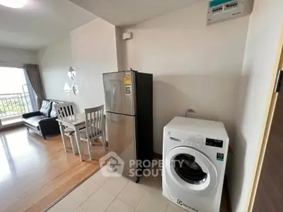 Modern apartment with open layout featuring fridge and washing machine