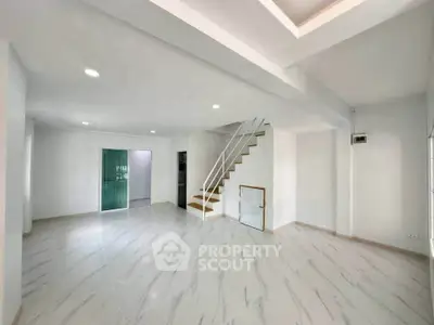 Spacious modern living room with sleek staircase and elegant flooring