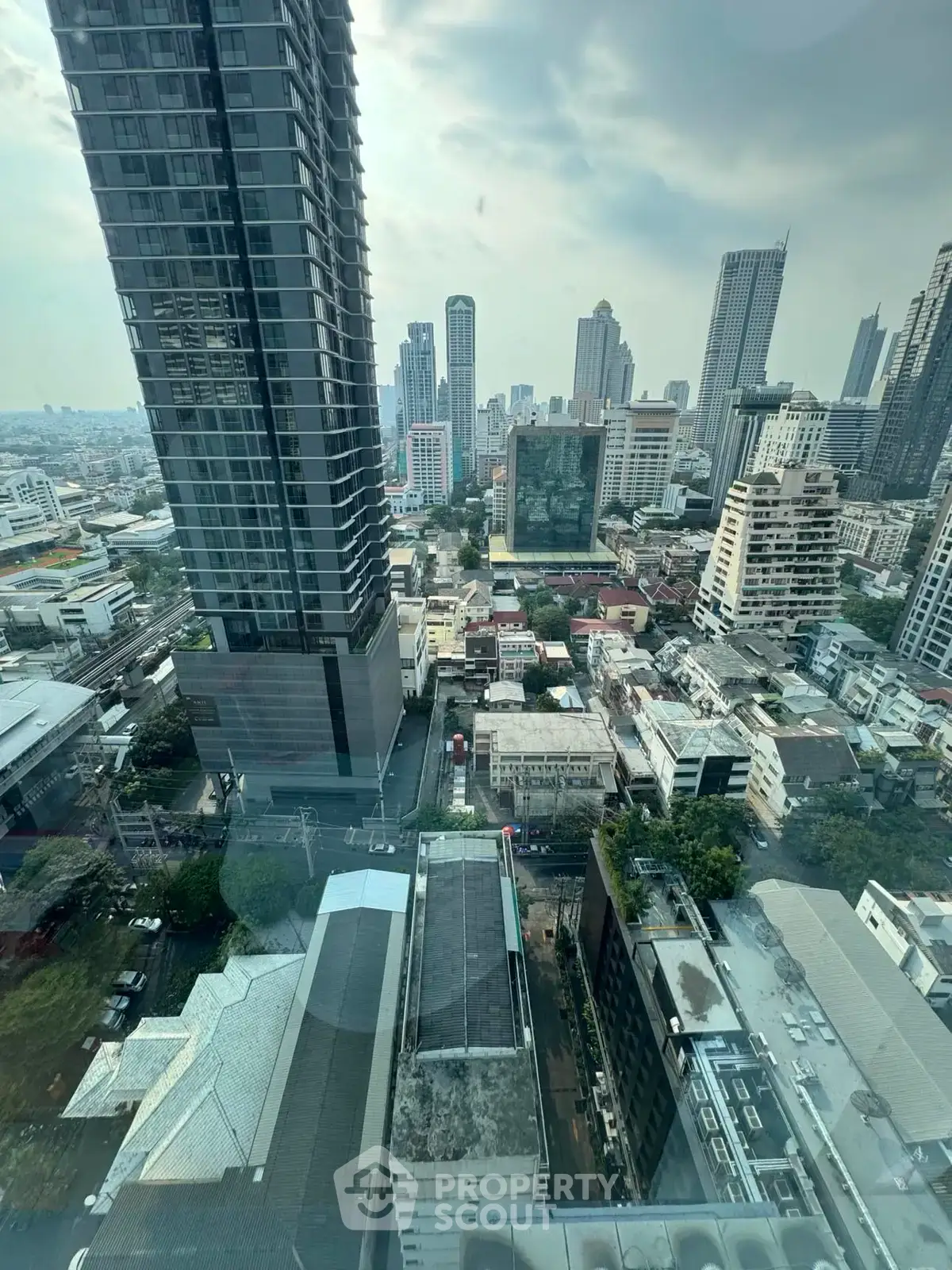 Stunning cityscape view from high-rise building showcasing urban skyline and architectural diversity.