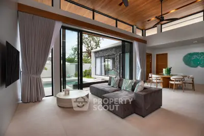 Luxurious modern living room with pool view, high ceilings, and elegant decor in a contemporary home.