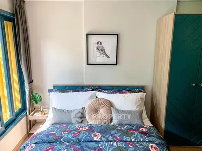Charming bedroom with vibrant bedding and stylish decor, perfect for a cozy retreat.