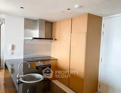 Modern kitchen with sleek cabinetry and built-in appliances in a stylish apartment.