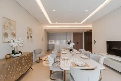 Luxurious open-plan living and dining area with elegant decor and modern kitchen.
