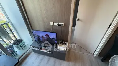 Modern apartment interior with TV and balcony view