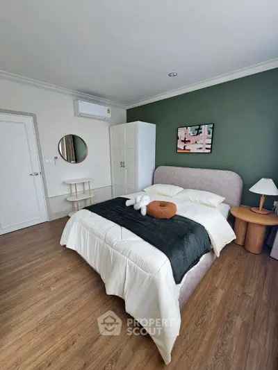 Modern bedroom with stylish decor and wooden flooring