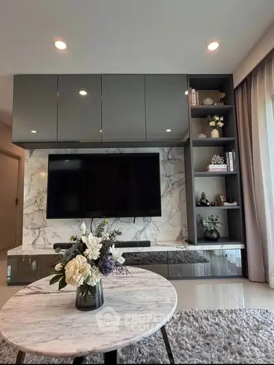 Modern living room with sleek TV unit and marble accents