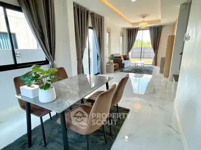 Luxurious open-plan living and dining area with elegant marble flooring and modern decor.