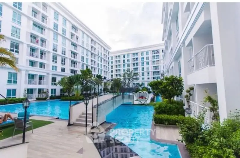 Luxurious condominium with stunning pool and lush greenery, perfect for modern living.