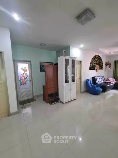 Spacious living room with modern decor and ample natural light