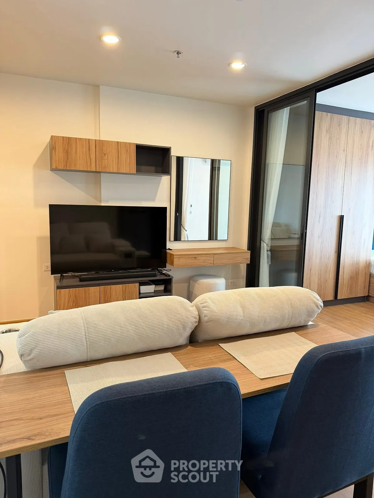 Modern living room with stylish wooden furniture and sleek TV setup