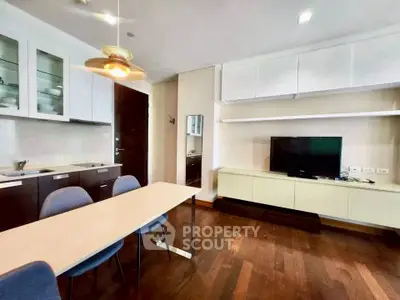 Modern living room with sleek furniture and wooden flooring in a stylish apartment.