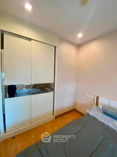 Cozy bedroom with modern sliding wardrobe and soft lighting