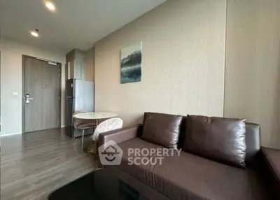 Modern living room with brown leather sofa and dining area in stylish apartment