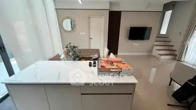 Modern living room with sleek design, marble countertop, and stylish decor in a contemporary home.