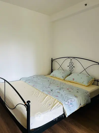 Cozy bedroom with elegant metal bed frame and soft bedding in a minimalist design.