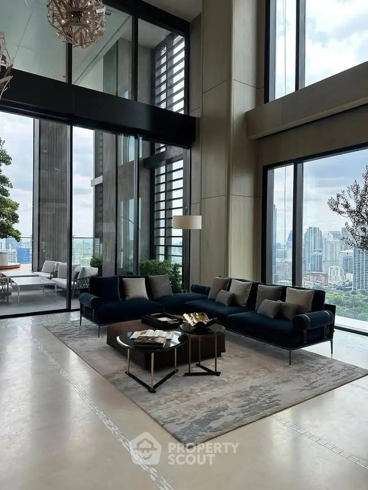 Luxurious high-rise living room with floor-to-ceiling windows and stunning city view.