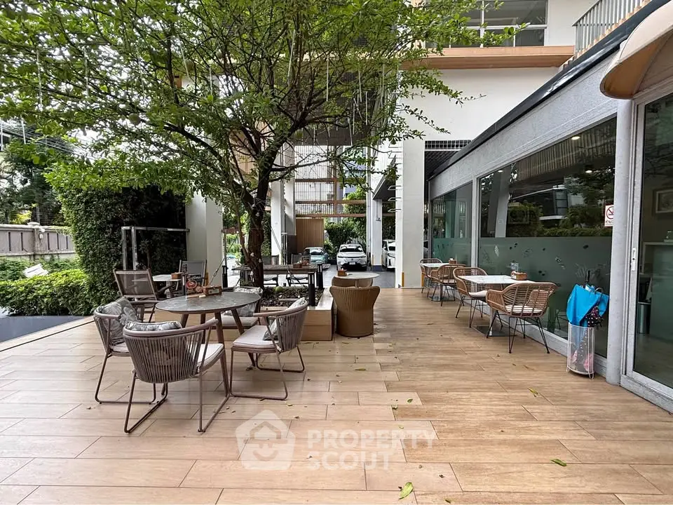 Charming outdoor patio with stylish seating and lush greenery, perfect for relaxation and social gatherings.