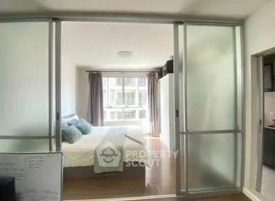 Modern bedroom with sliding glass doors and ample natural light