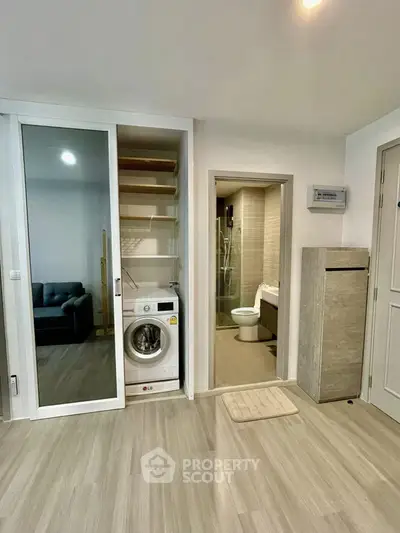 Modern apartment interior with washing machine and bathroom view