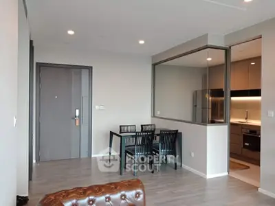 Modern open-plan living room with dining area and sleek kitchen